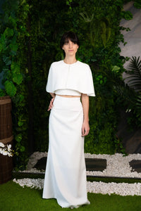 Ensemble de mariée minimaliste composé d’une jupe, d’un top et d’un petit cape-poncho, disponible à acheter en ligne
